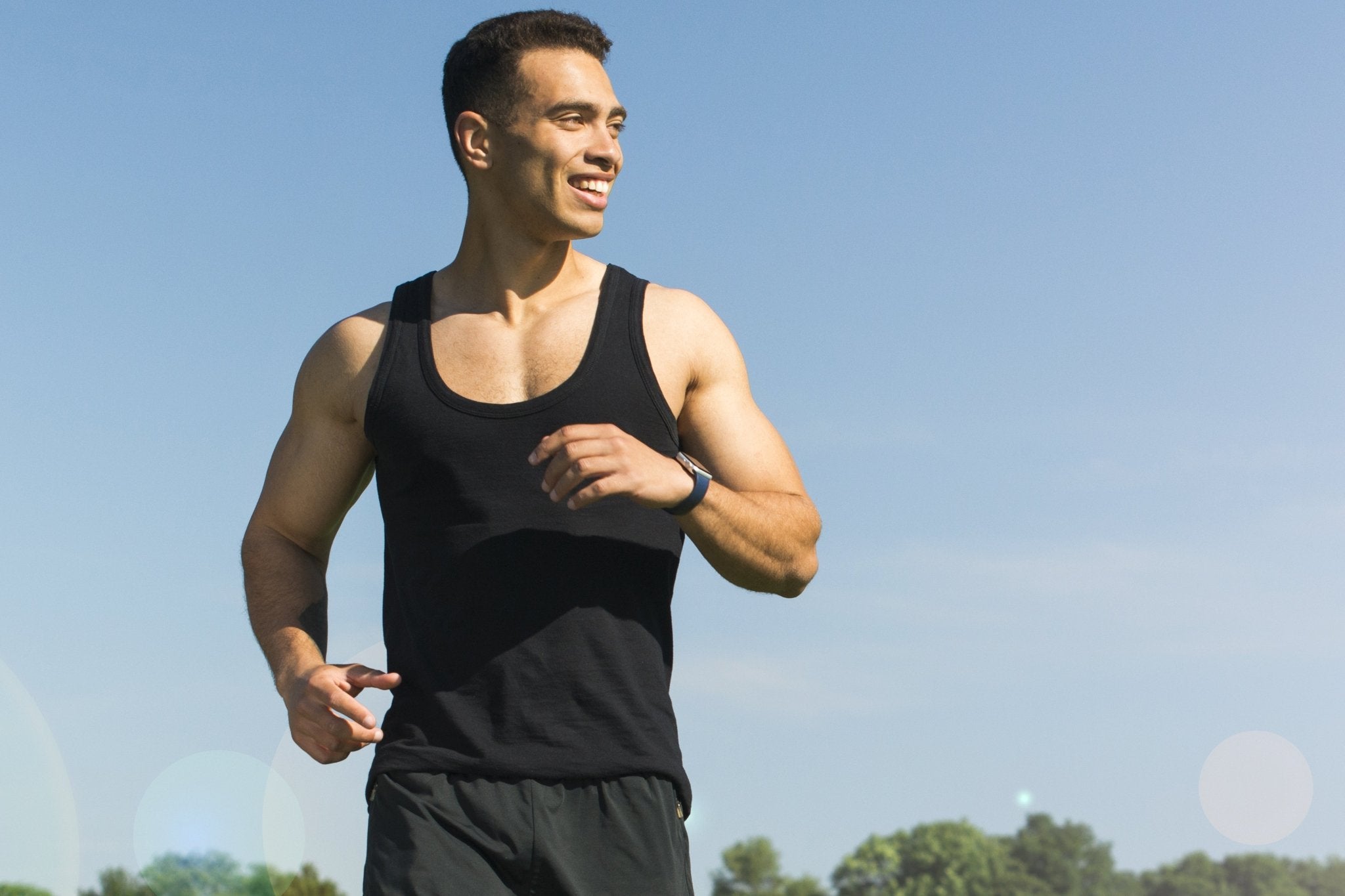 Fit man jogging outdoors in athletic wear, promoting healthy lifestyle and wellness