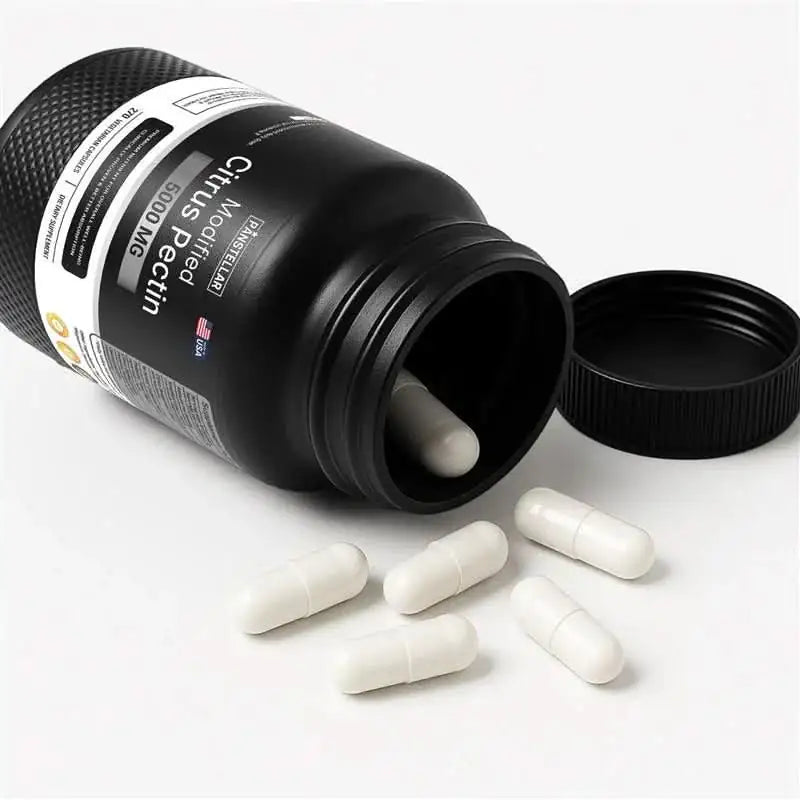 Modified citrus pectin supplement capsules spilling from black bottle on white background